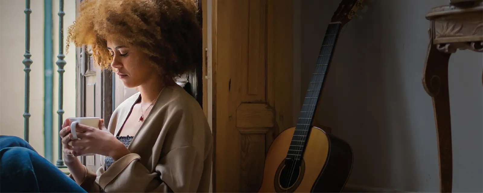 Person holding mug and relaxing.