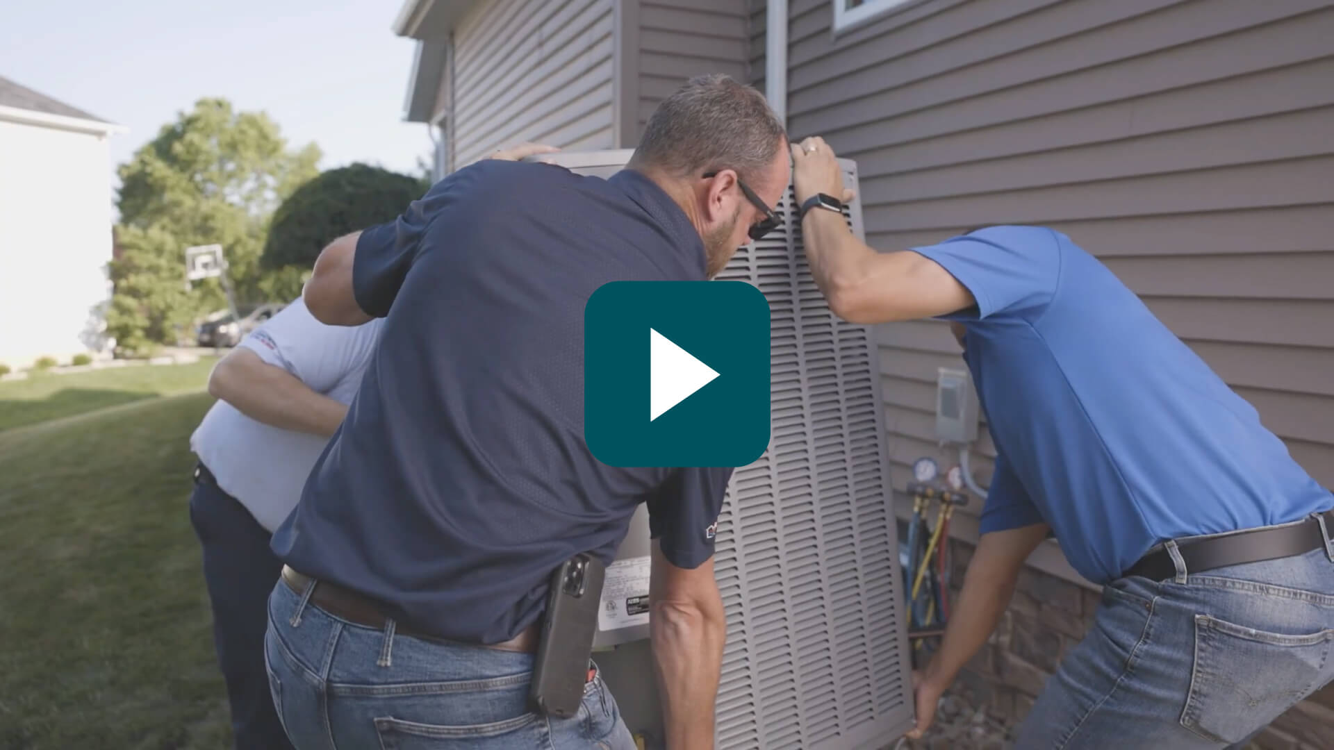 HVAC technicians installing a unit.